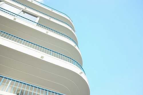 blue sky worms eye view photography of building railing